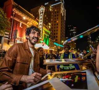 Dev Patel at signing autographs outside the Paramount Theater at the premiere of Monkey Man at SXSW 2024